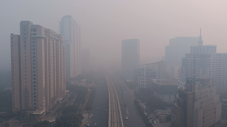 An photo of the National Capital Region of India. Smog obscures the view of the city.